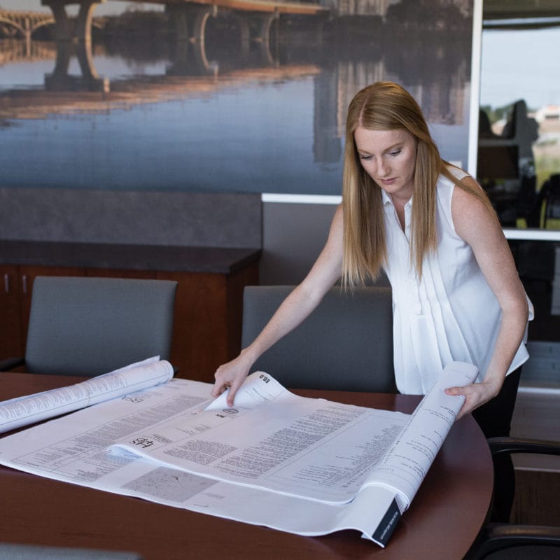 Jennifer looking at blueprints